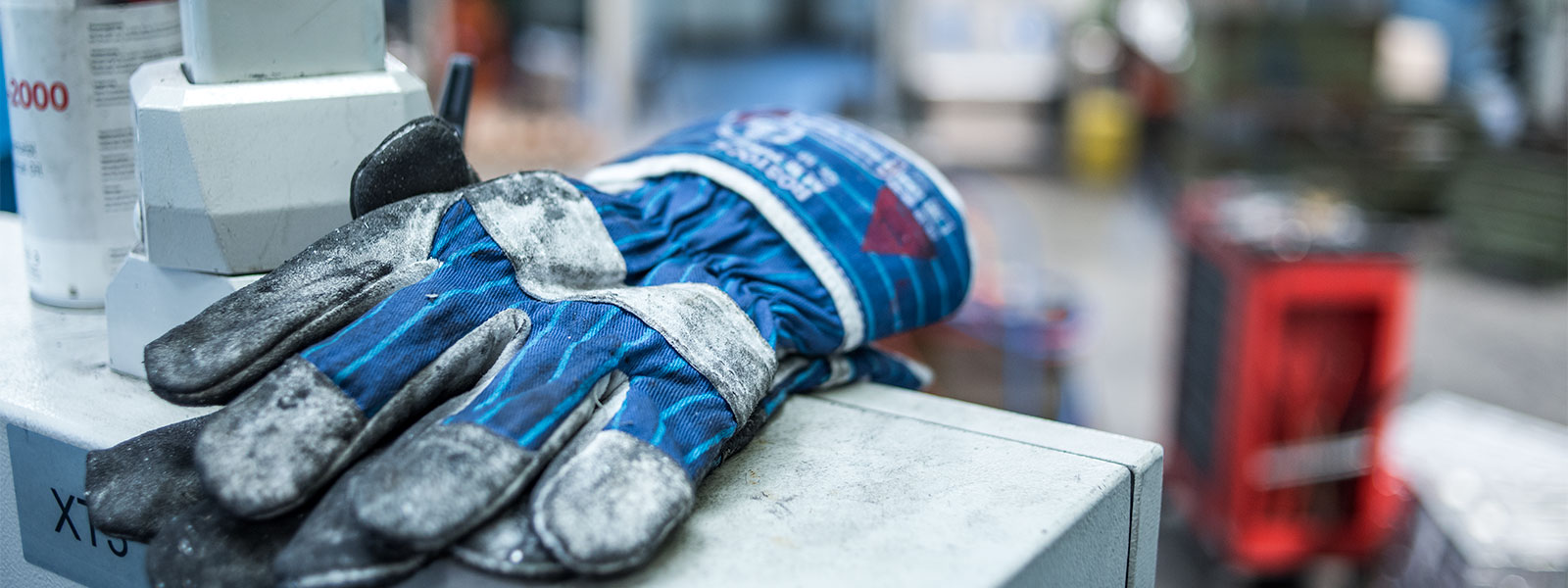 Work glove on the control unit of a die casting machine