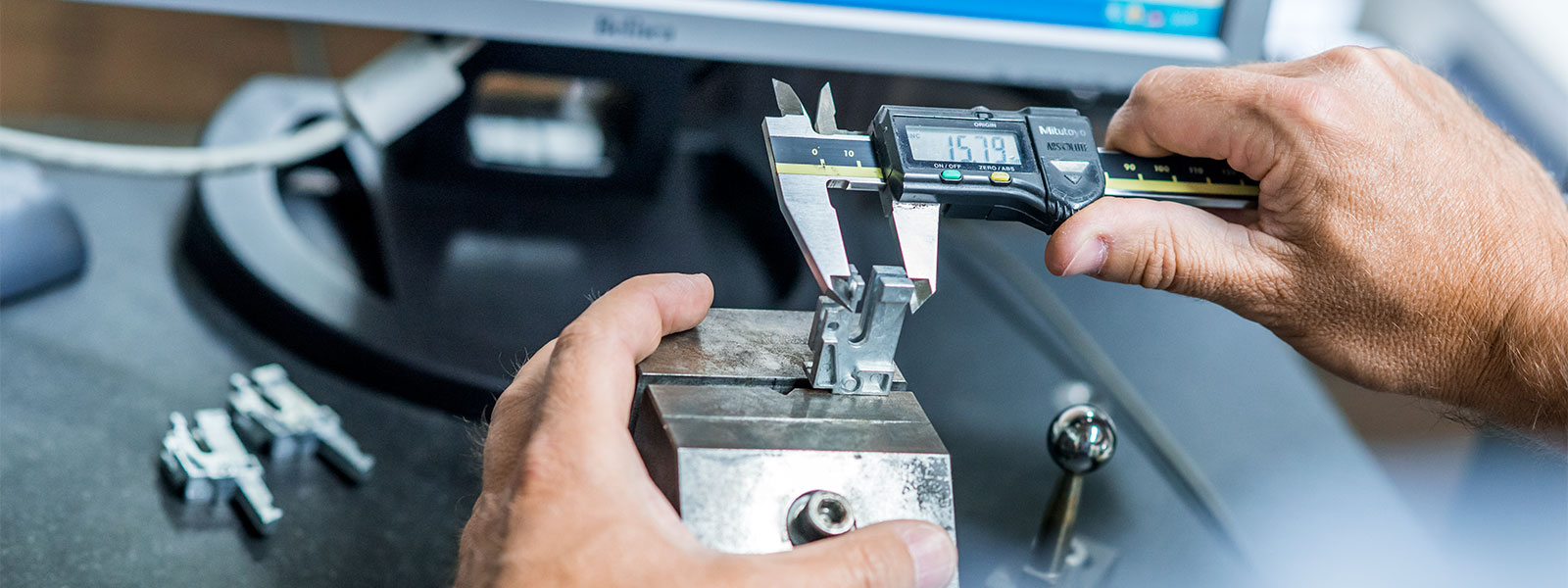 Measuring a zinc die cast component with a Vernier scale